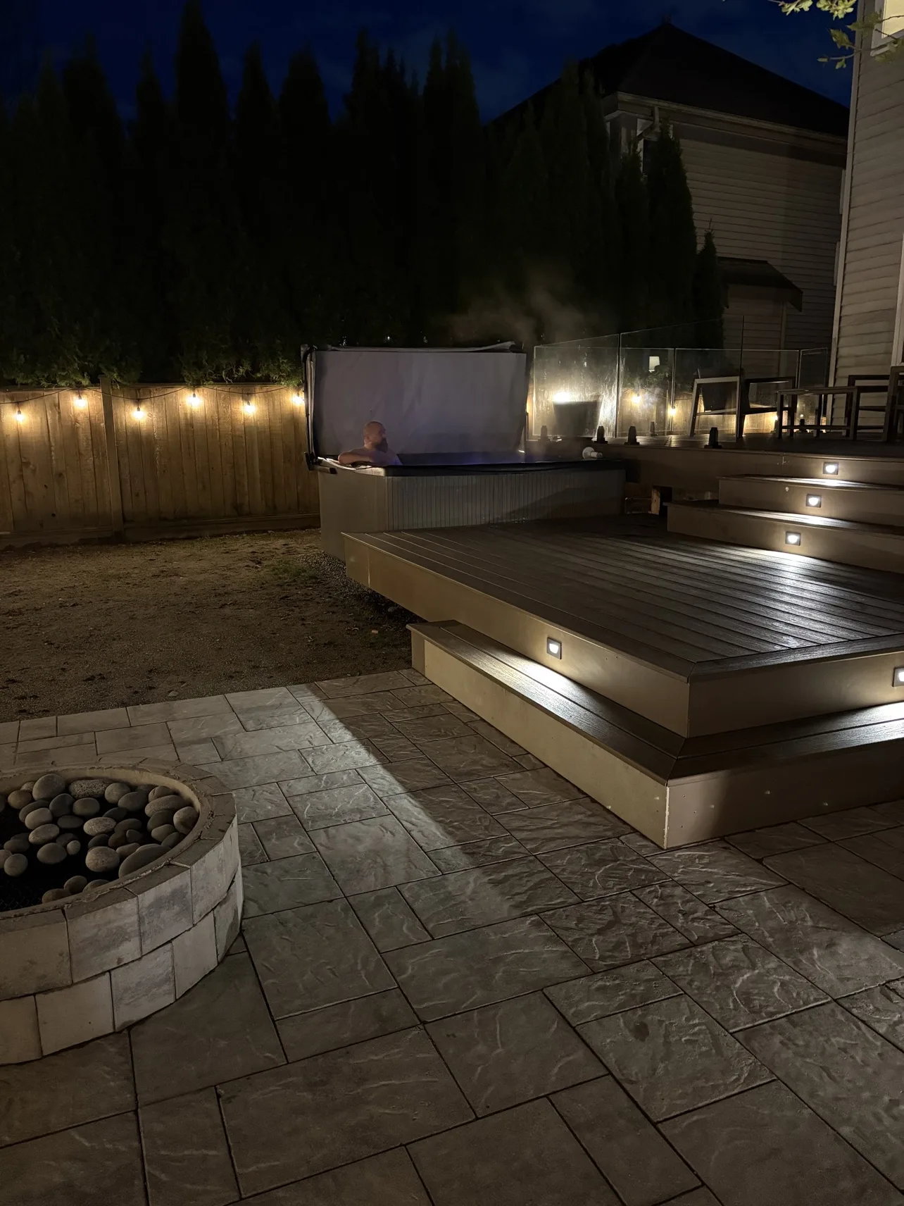 Finished deck at dusk with glass railing