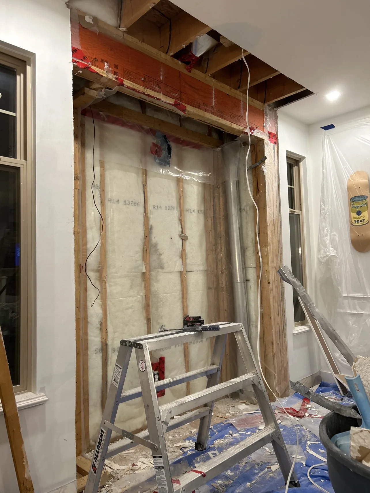 Dining room mid-renovation, wall opened to studs