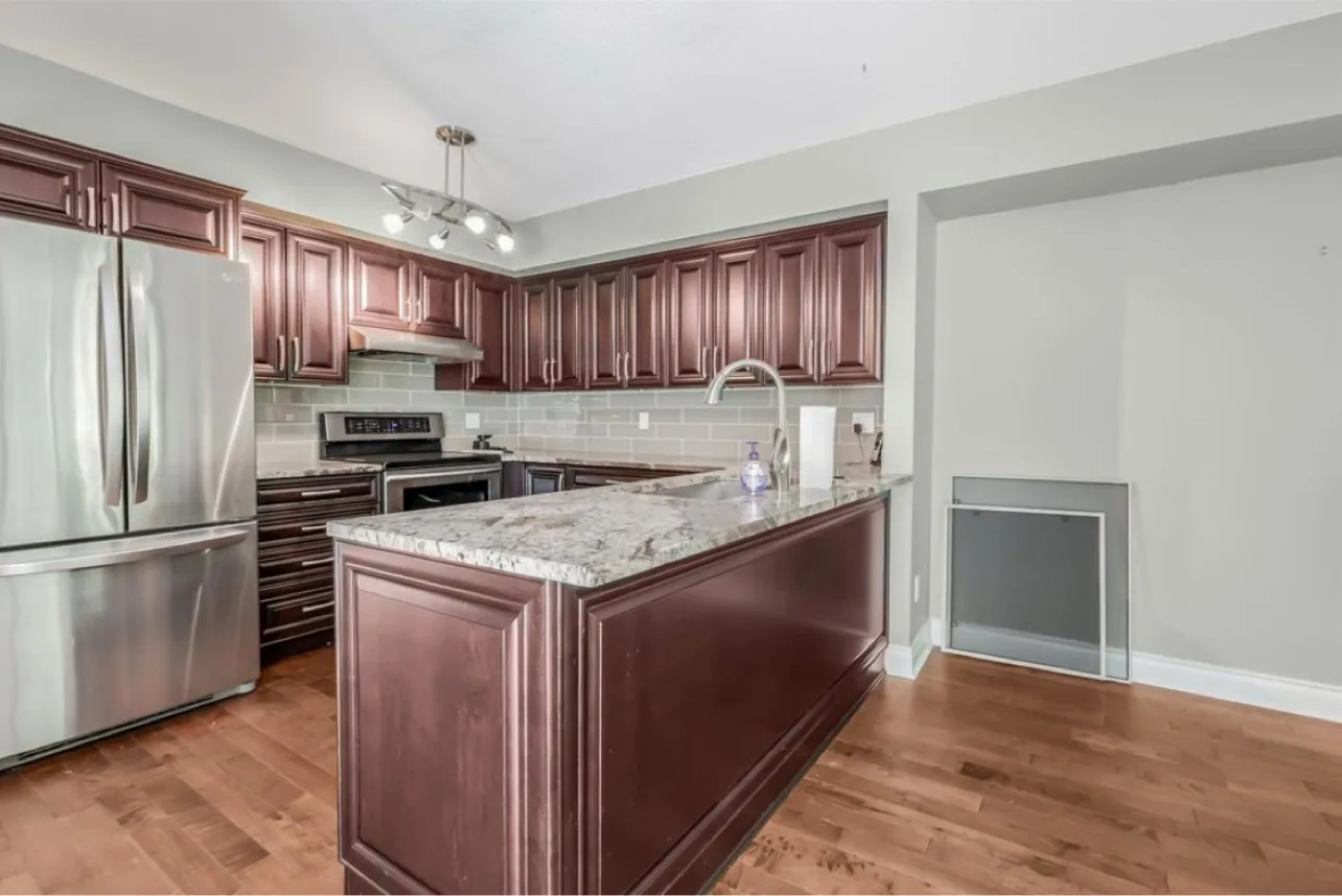 Ravine condo kitchen before: dated cherry kitchen