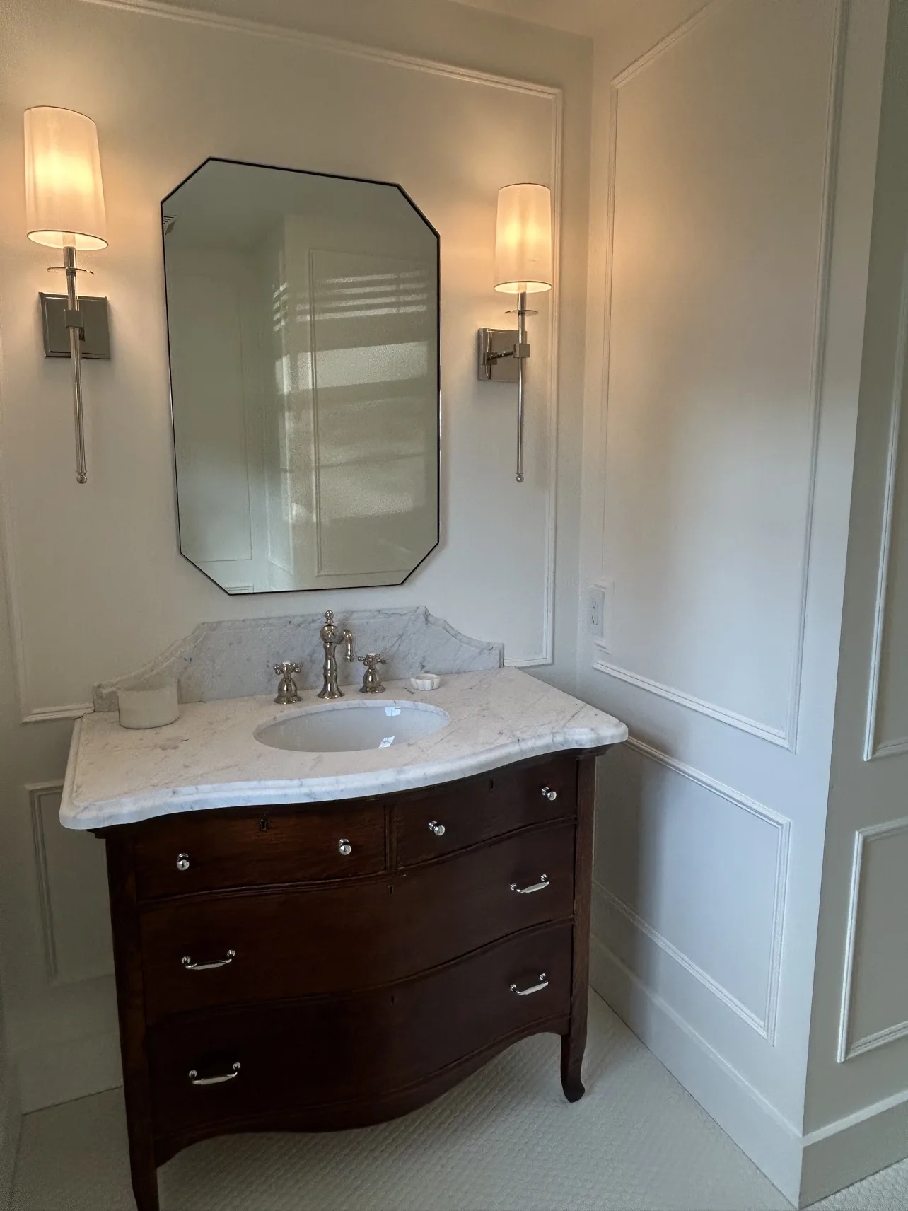 Powder room finished: marble-top vanity, front